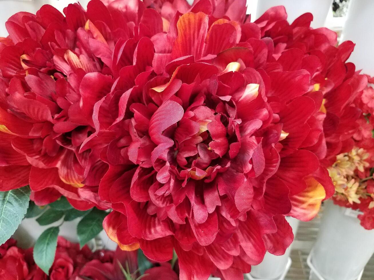 artificial red flowers with green leaves 7710412 Stock Photo at Vecteezy