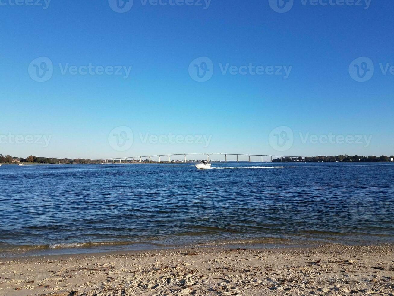 beach and water and bridge at Solomons Island Maryland with boats photo