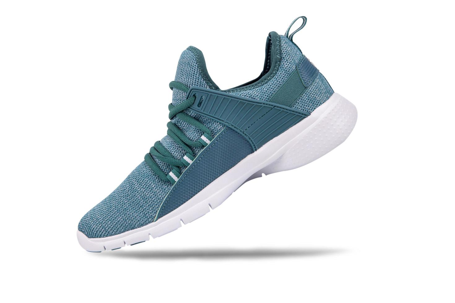 Green sneakers or sport running shoe isolated on a white background photo