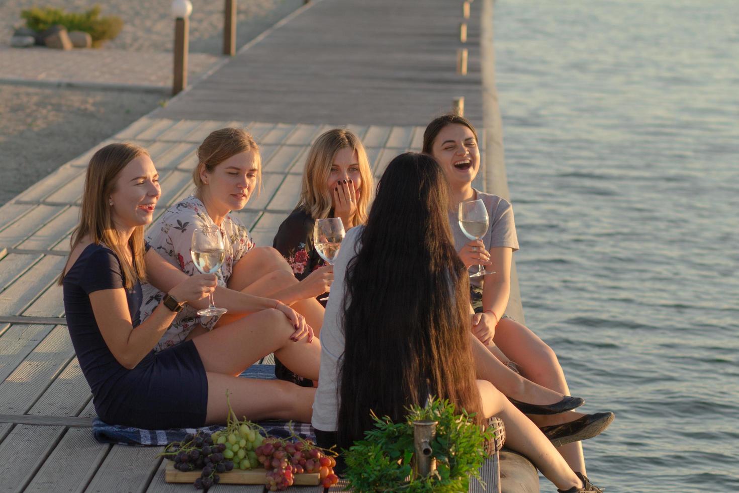 Summer party of young beautiful womans with wine, sea resort relaxing in sunny day photo