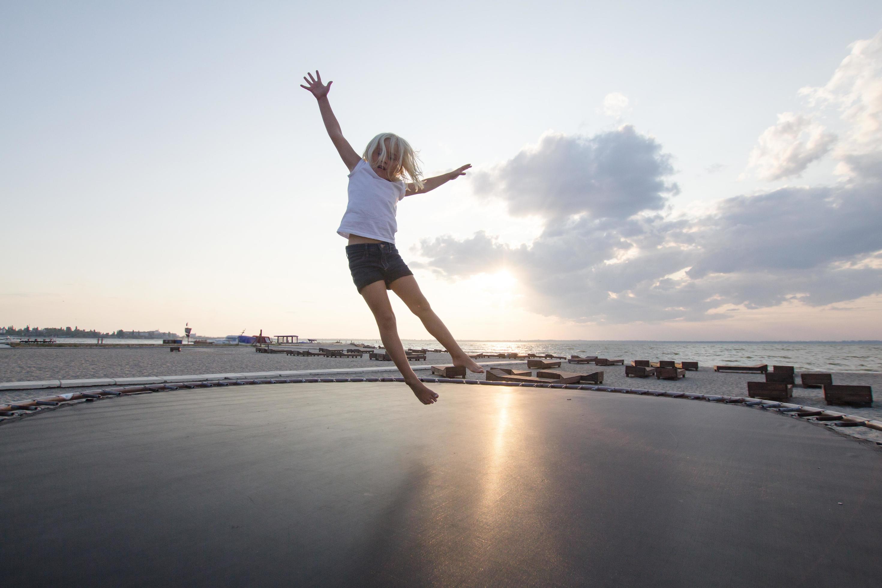 little girl jump and having good time on trampoline in summer time 7713664 Stock Photo at Vecteezy