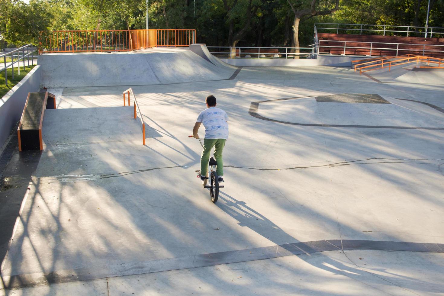 BMX rider training and do tricks in street plaza, bicyxle stunt rider in cocncrete skatepark photo