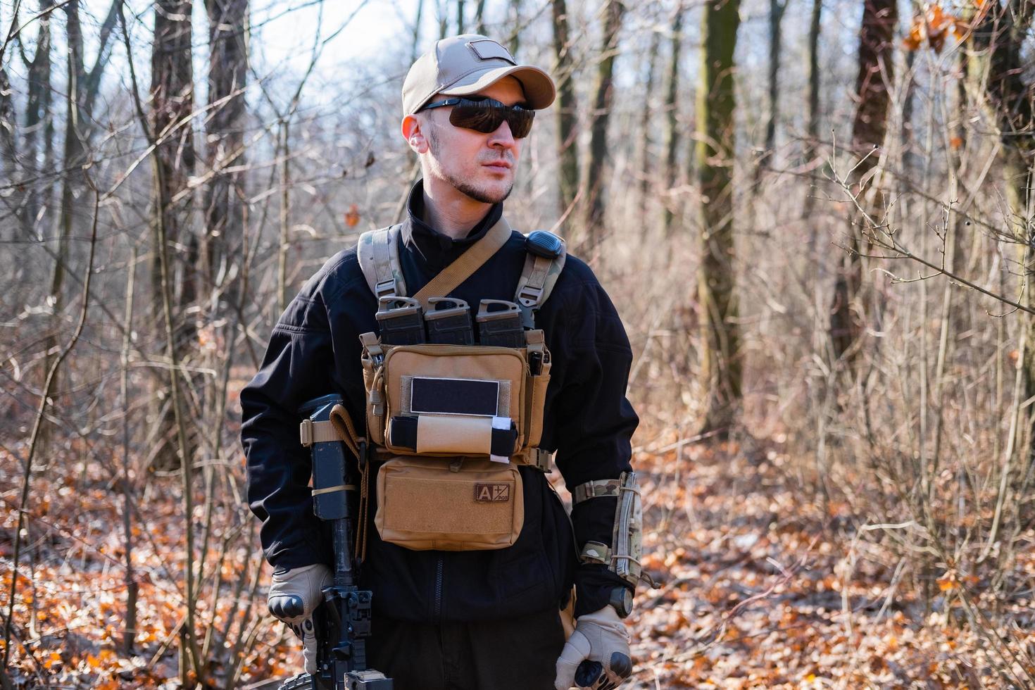 Male from private military company with rifle in the forest photo