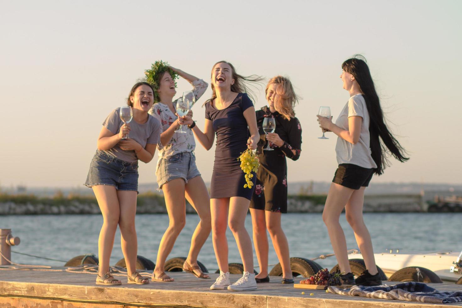 fiesta de verano de jóvenes hermosas mujeres con vino, balneario relajante en un día soleado foto