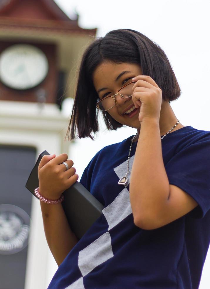 Teen reading clock tower. photo