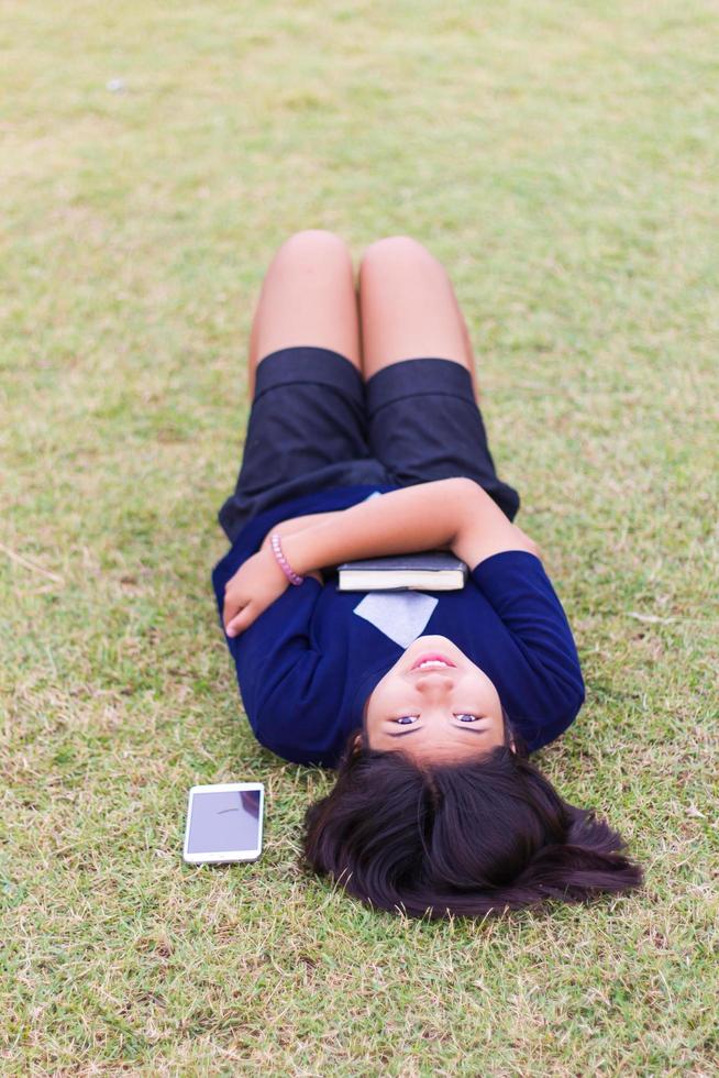 Young girl lying with a book. photo