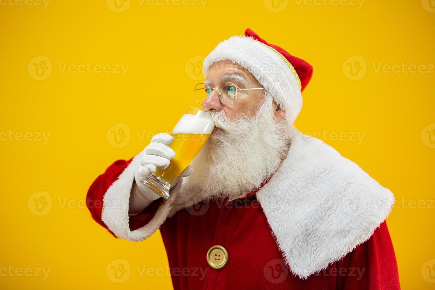 Santa Claus drinking a glass of beer. Rest time. Alcoholic drink at the holidays. Drink with moderation. Craft beer. Merry Christmas. photo