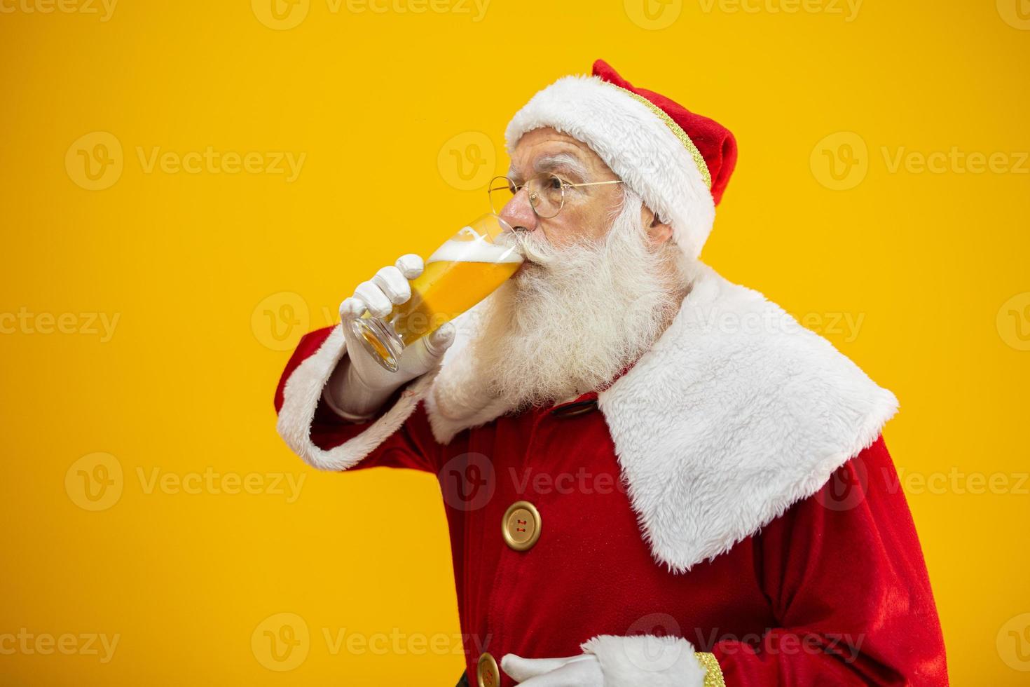 Santa Claus drinking a glass of beer. Rest time. Alcoholic drink at the holidays. Drink with moderation. Craft beer. Merry Christmas. photo