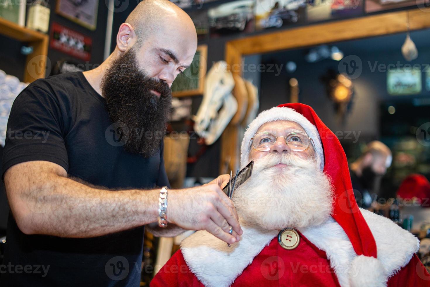 Santa Claus shaving in barbershop. Looking in the mirror. Getting ready for Christmas. Beautifying for the holidays. Bearded. Cuting. photo