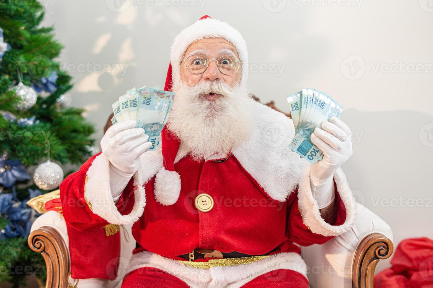 Santa Claus counting Brazilian money bills. Real Notes. 100 Reais ...