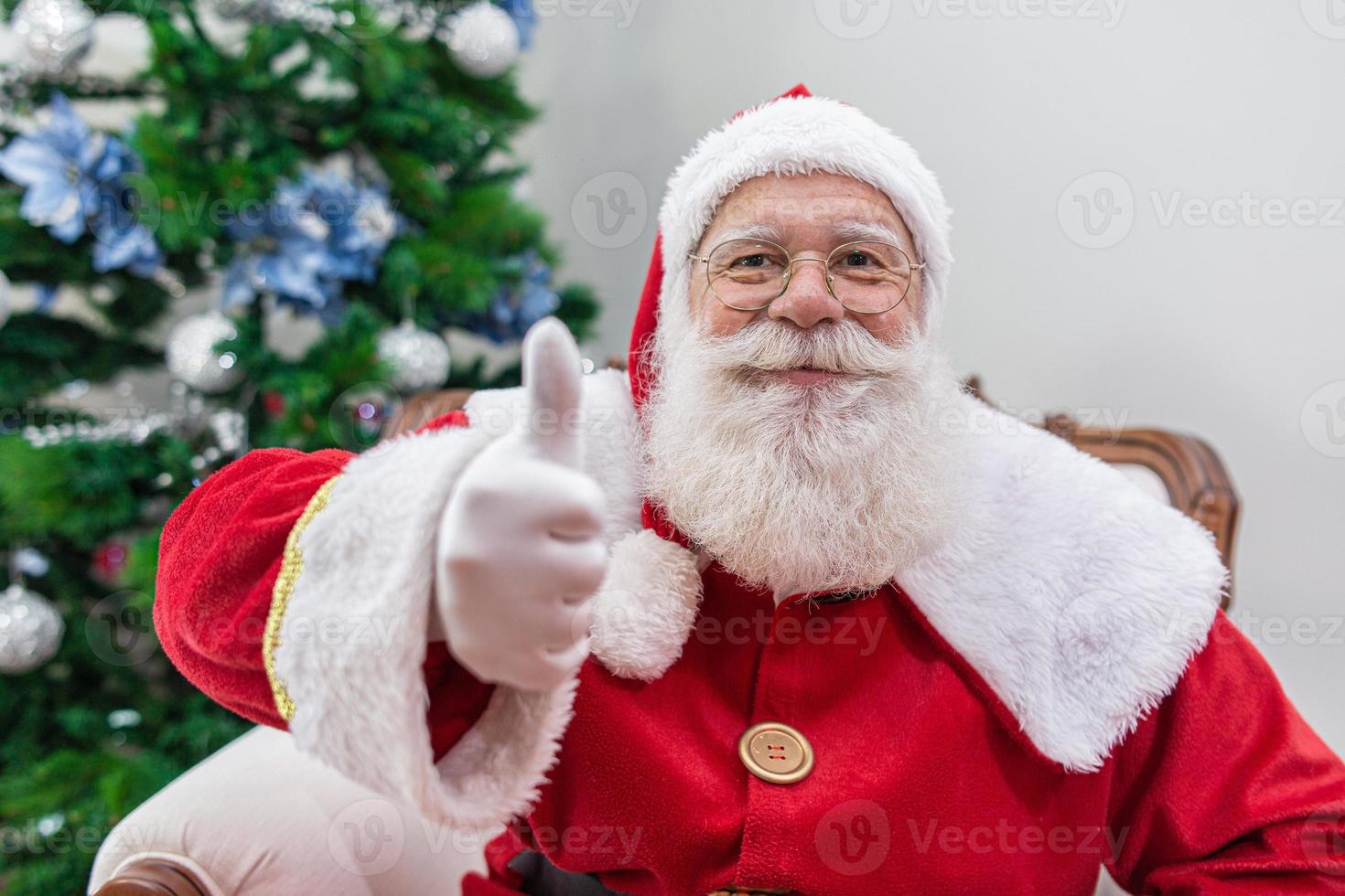 Santa Claus showing thumb-up. Santa Claus with real beard and great smiling giving thumb up. photo