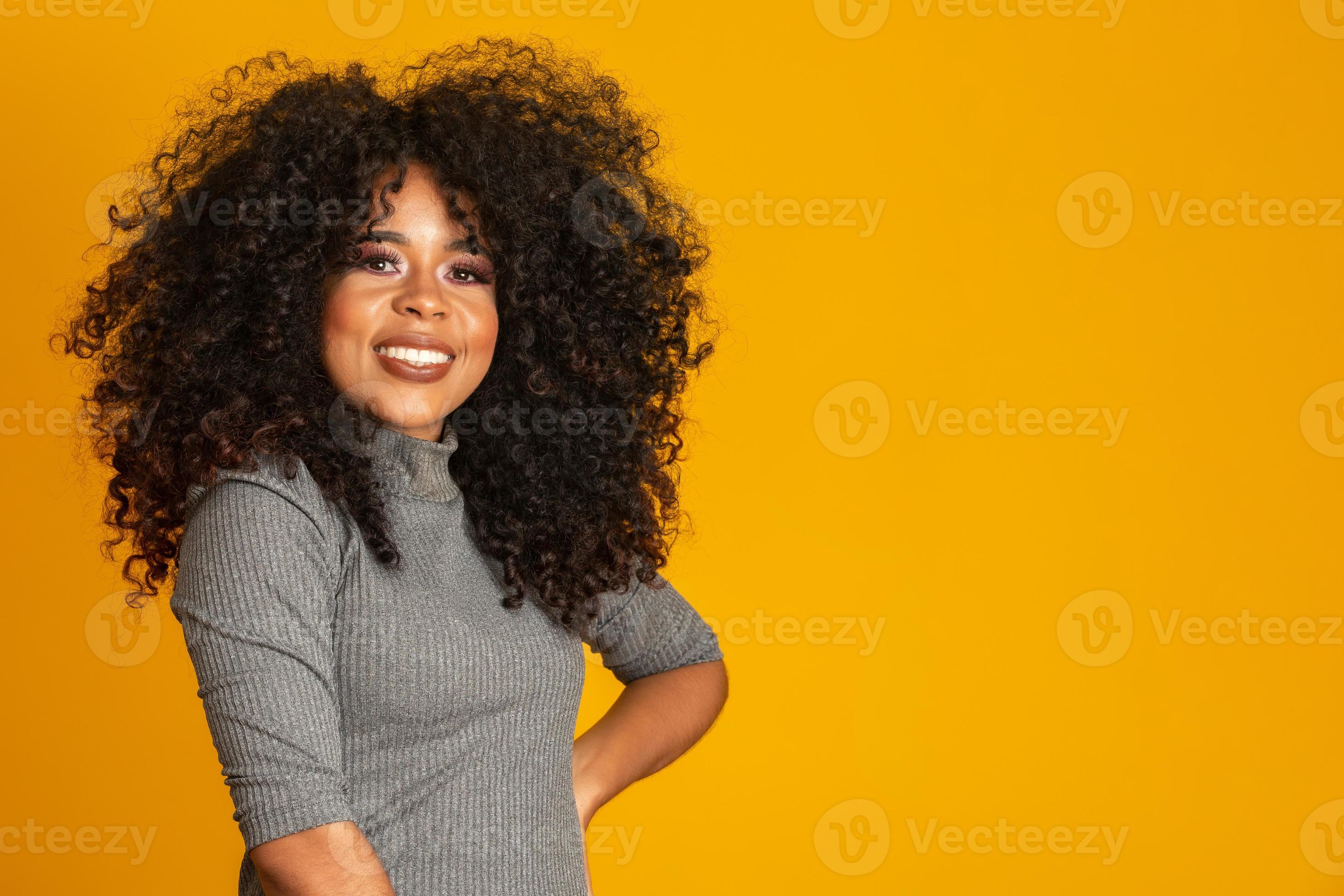 Beauty portrait of african american woman with afro hairstyle and glamour  makeup. Brazilian woman. Mixed race. Curly hair. Hair style. Yellow  background. 7717650 Stock Photo at Vecteezy