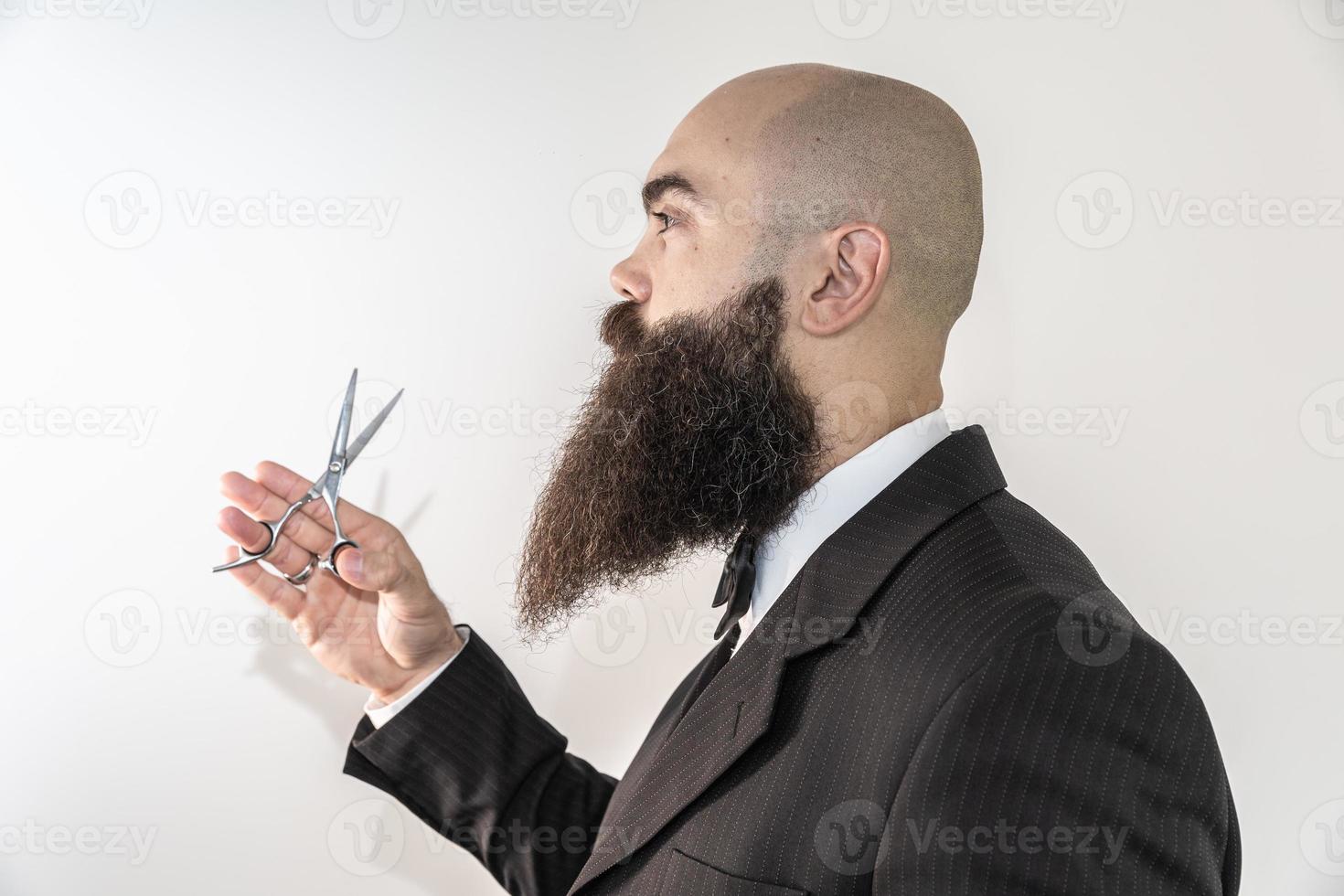 barber with long beard using scissors photo