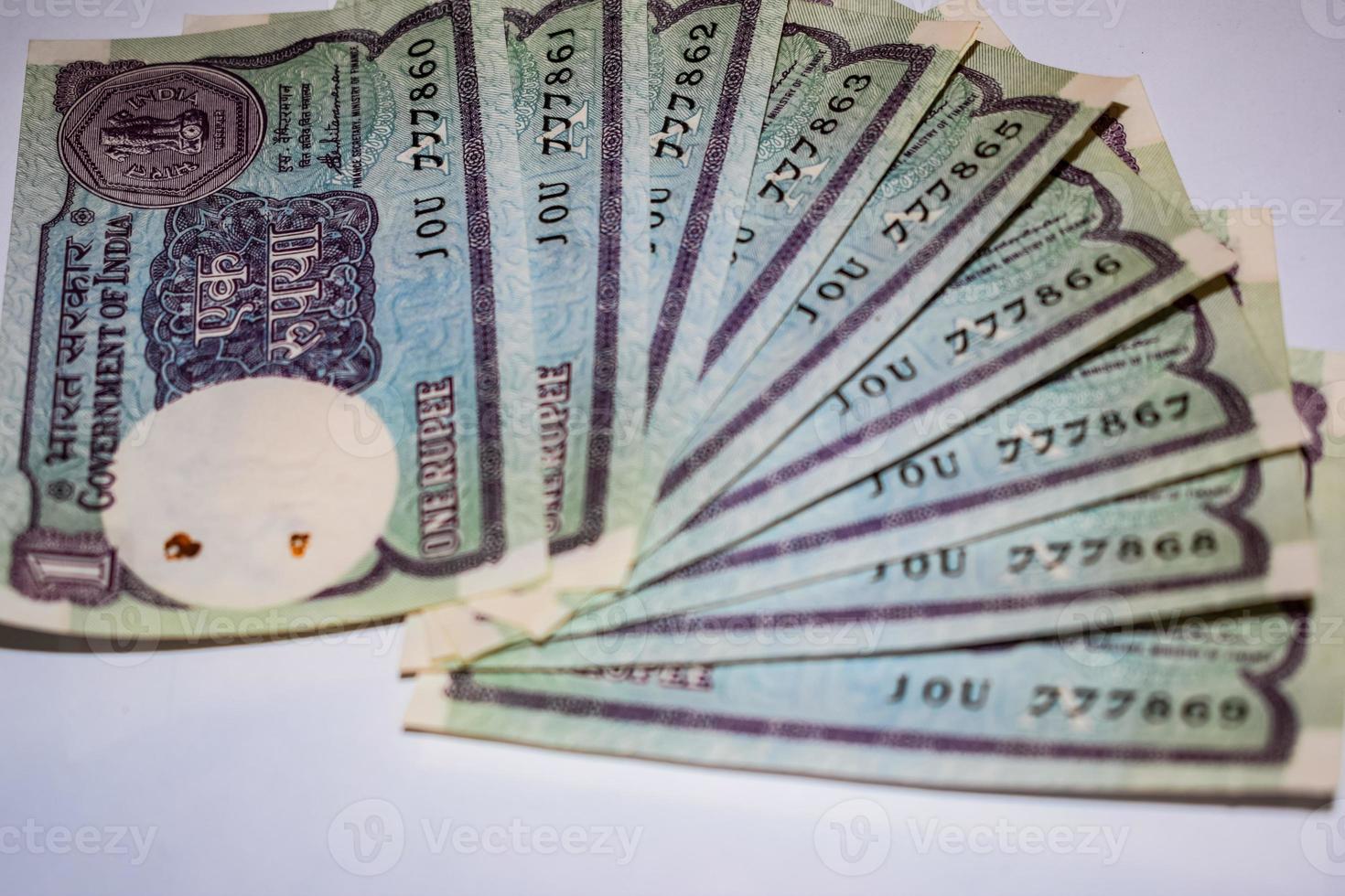 Old One Rupee notes combined on the table, India money on the rotating table. Old Indian Currency notes on a rotating table, Indian Currency on the table photo