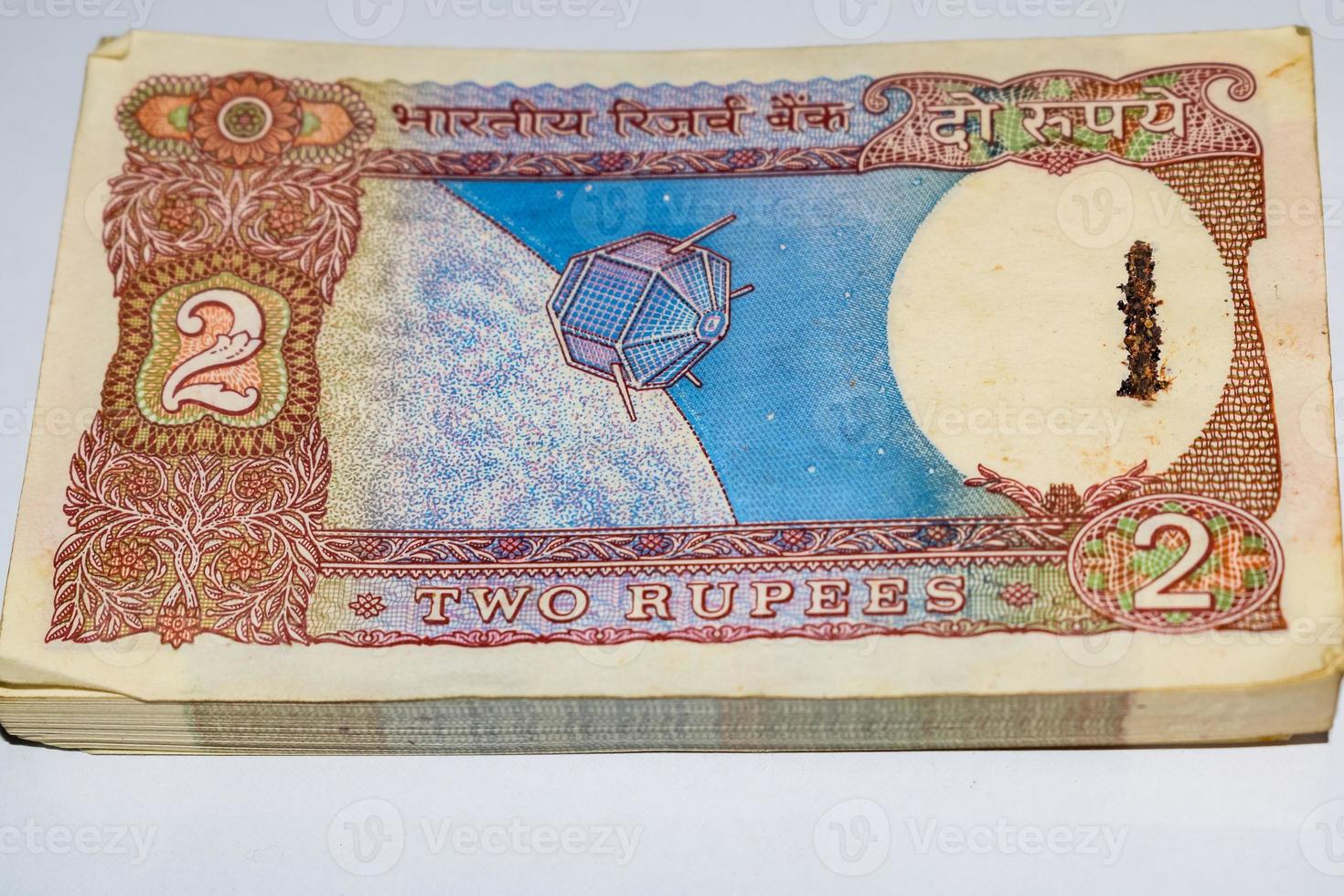 Old Two Rupee notes combined on the table, India money on the rotating table. Old Indian Currency notes on a rotating table, Indian Currency on the table photo