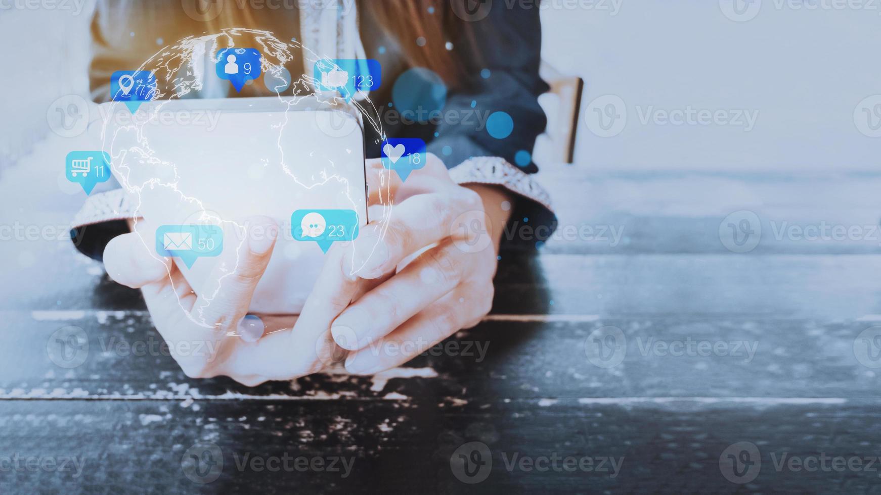 Concept with notification icons of social media on smart phone. Woman's hands holding her phone with notification icons of love, like, message, chat, comment and shopping above smartphone screen. photo