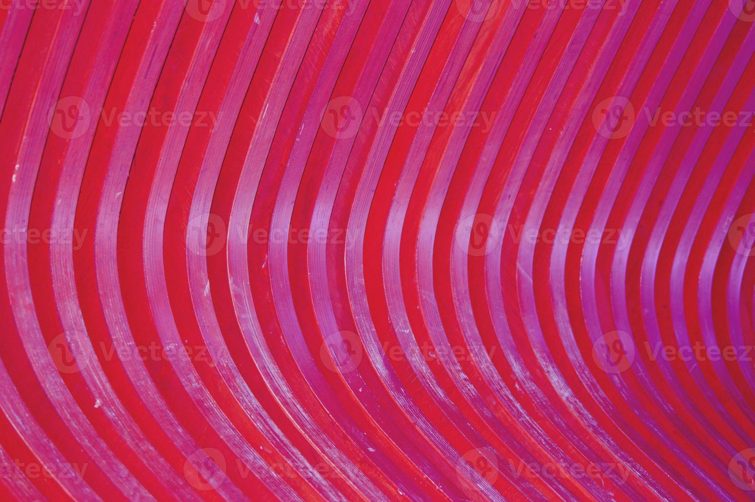 Trendy abstract pattern of wooden slats, wood texture painted in burgundy. Glare of the Sun on a curved surface, a beautiful color gradient. photo