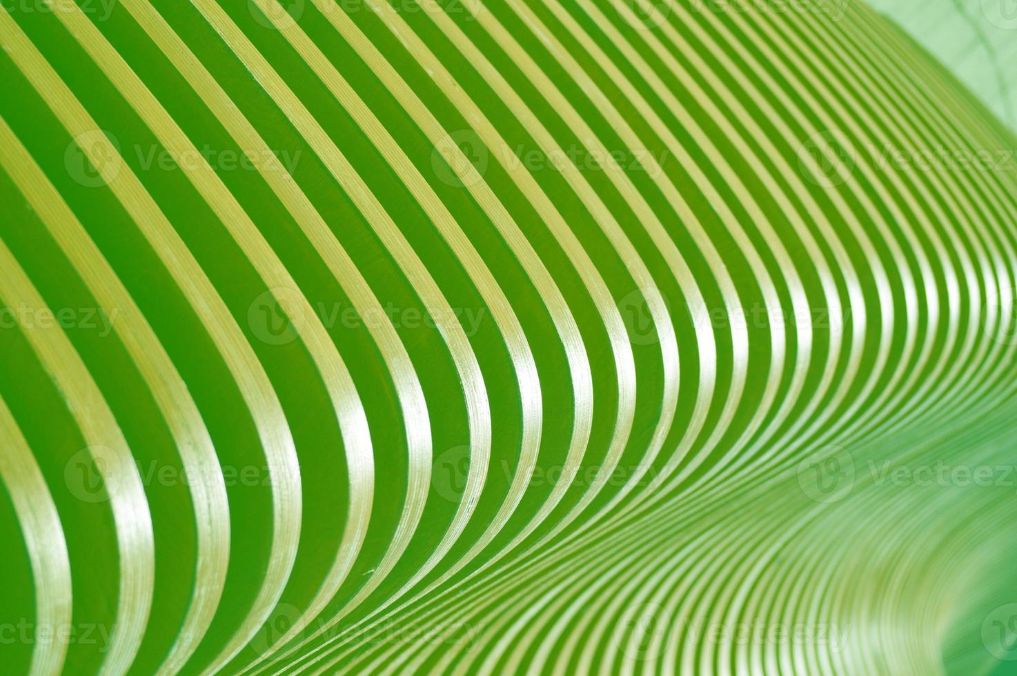 Beautifully curved wooden green slats. Smooth abstract lines as a background. Element of finishing the facade of the building. photo