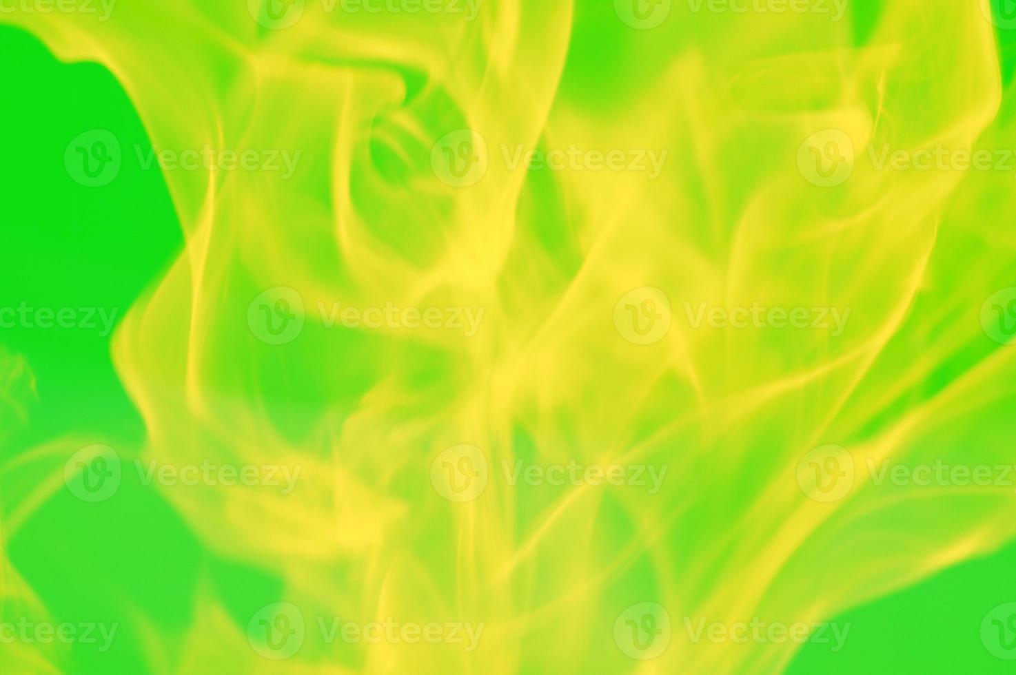 Abstract yellow lights, glare of light, flame, smoke - blurred on a green background. Bright colored background. photo