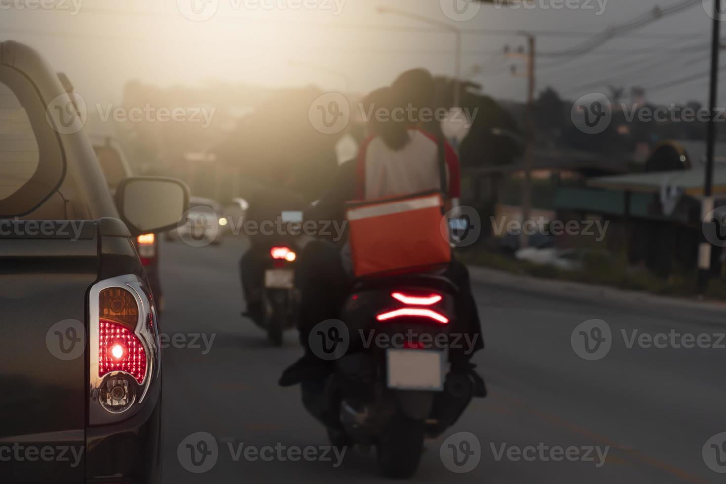 Abstract and blurred of rear side of pickup car open tail light of brake car. Driving on the road with other motorsidcle in the evening. photo