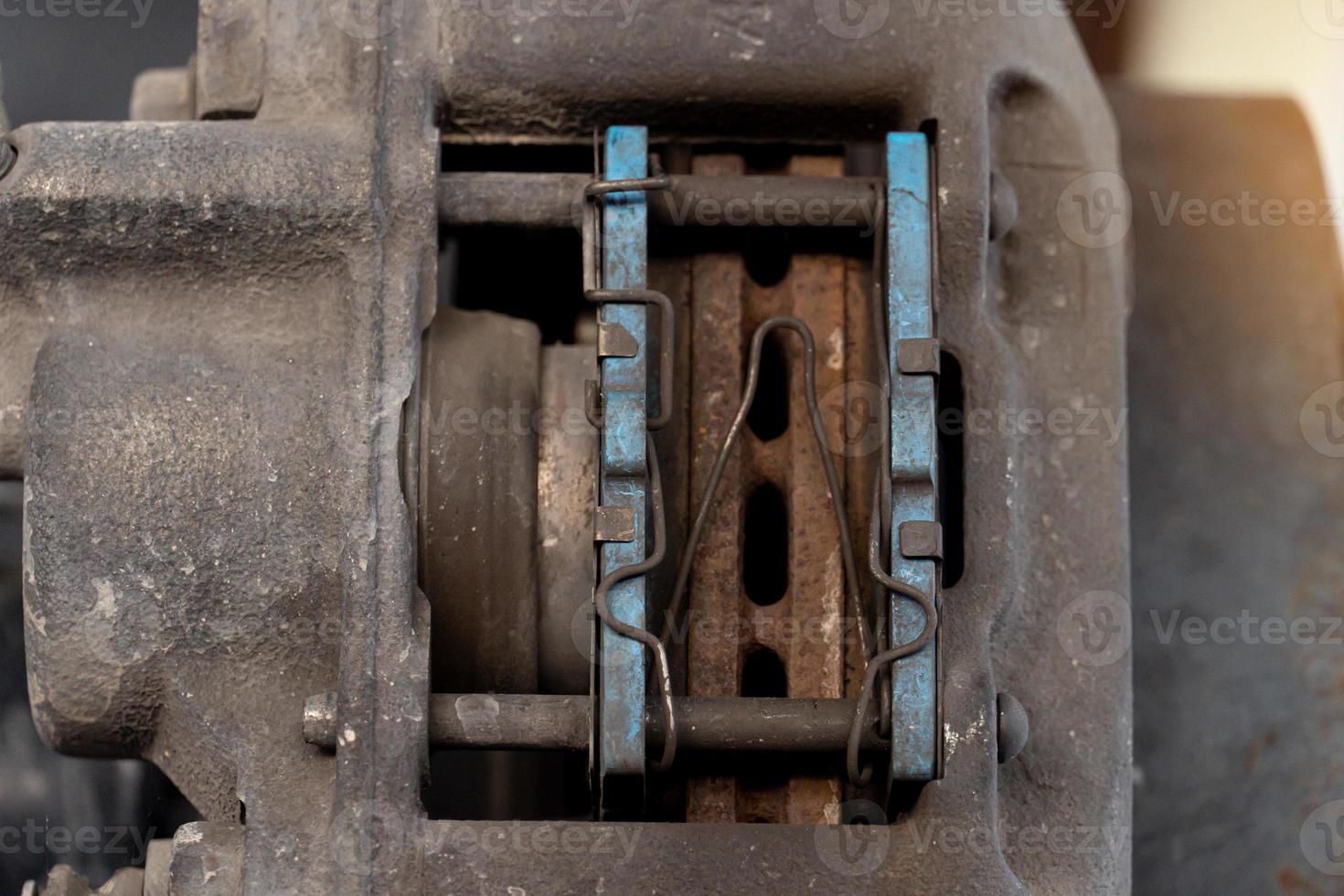 Close-up view of the inside of a caliper with used of breaker pads. car maintenance background. photo
