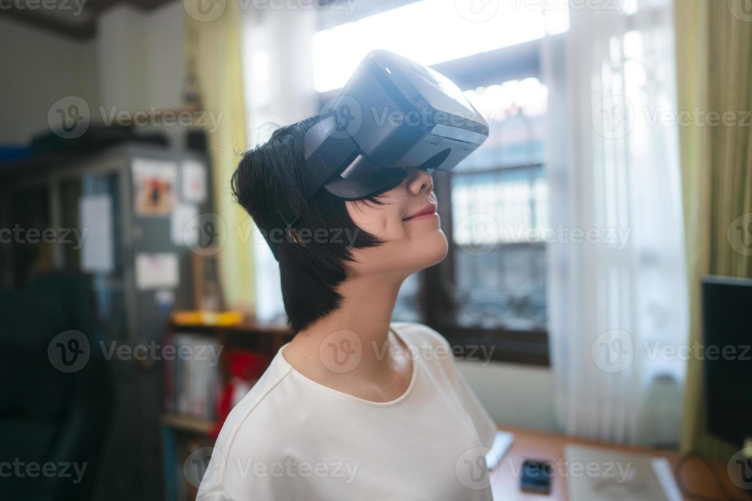 Young adult asian woman wear VR headset for modern technology lifestyle. photo