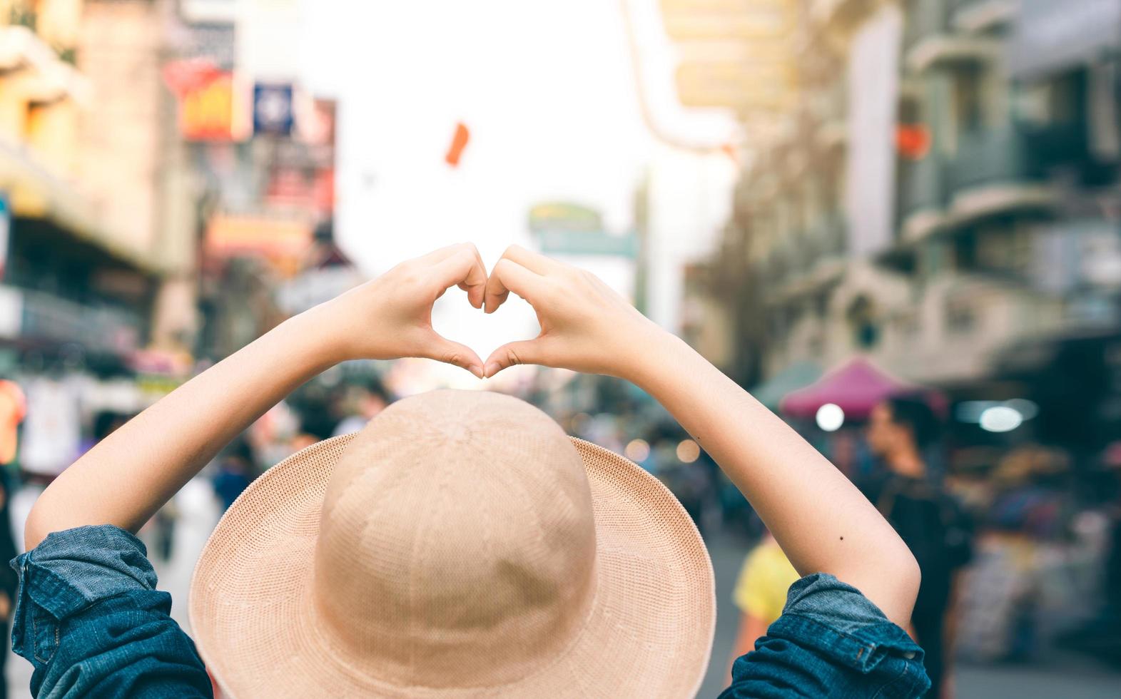 Asian traveller woman person hand with heart gesture. photo