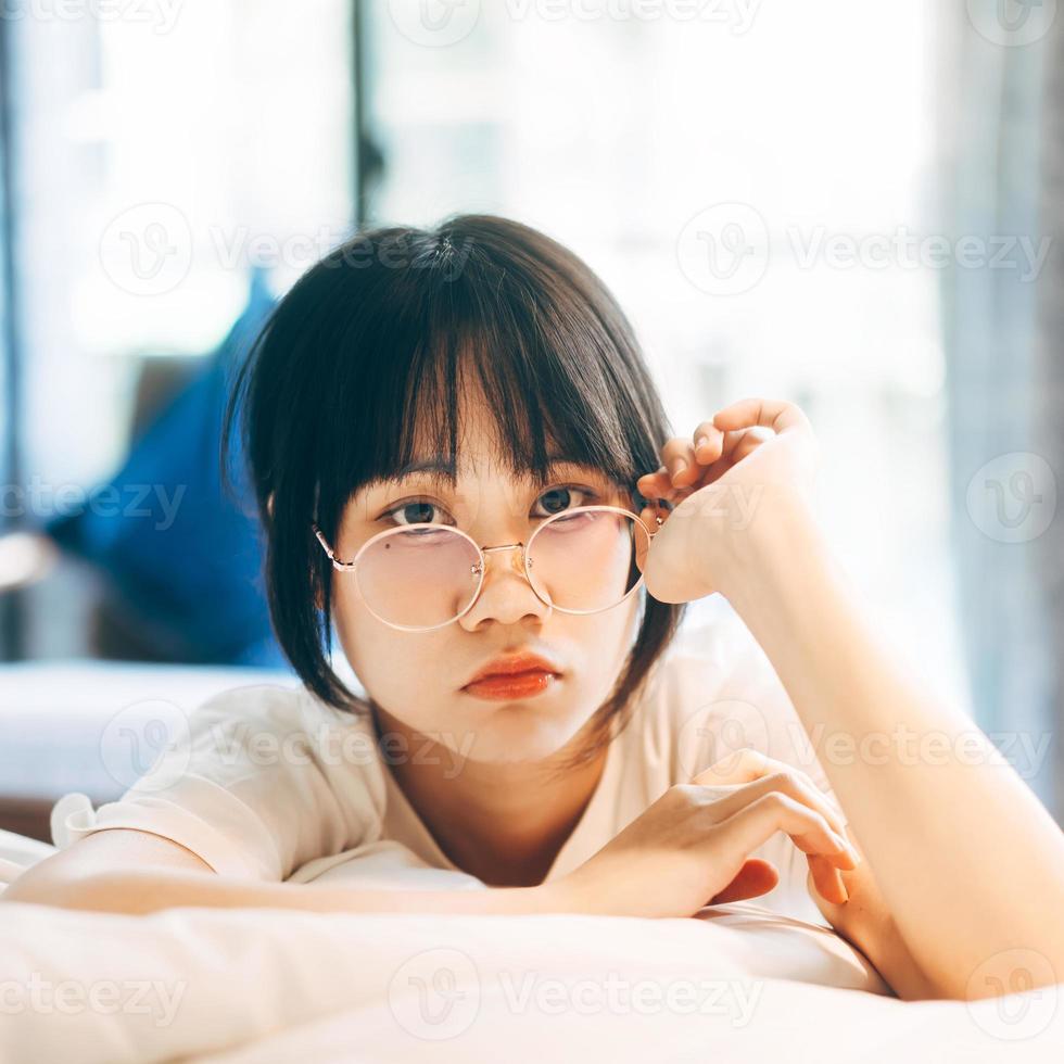 Portrait young adult asian woman relax in bedroom after wake up stay at home with eye attractive. photo