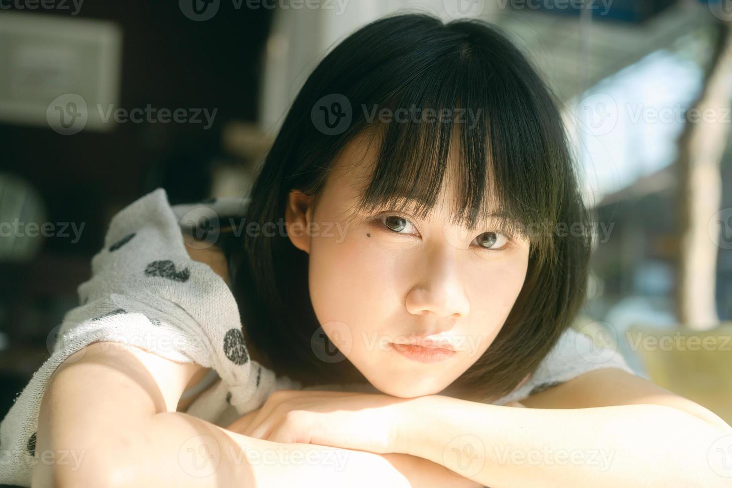 Portrait of young adult asian woman looking camera. photo