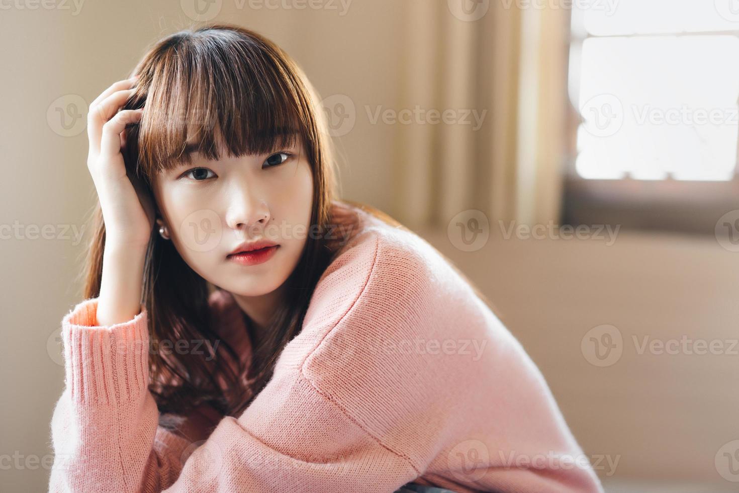 Portrait young asian cute student woman wear pink sweater. photo