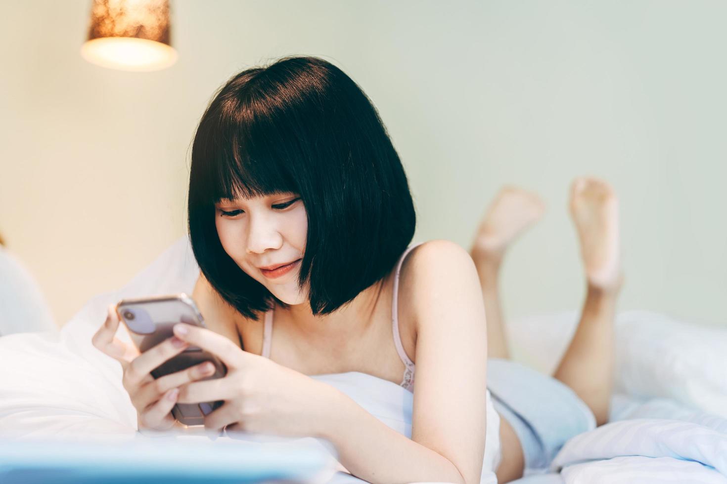 Young adult single woman using smartphone in the moring for online app mental health. photo