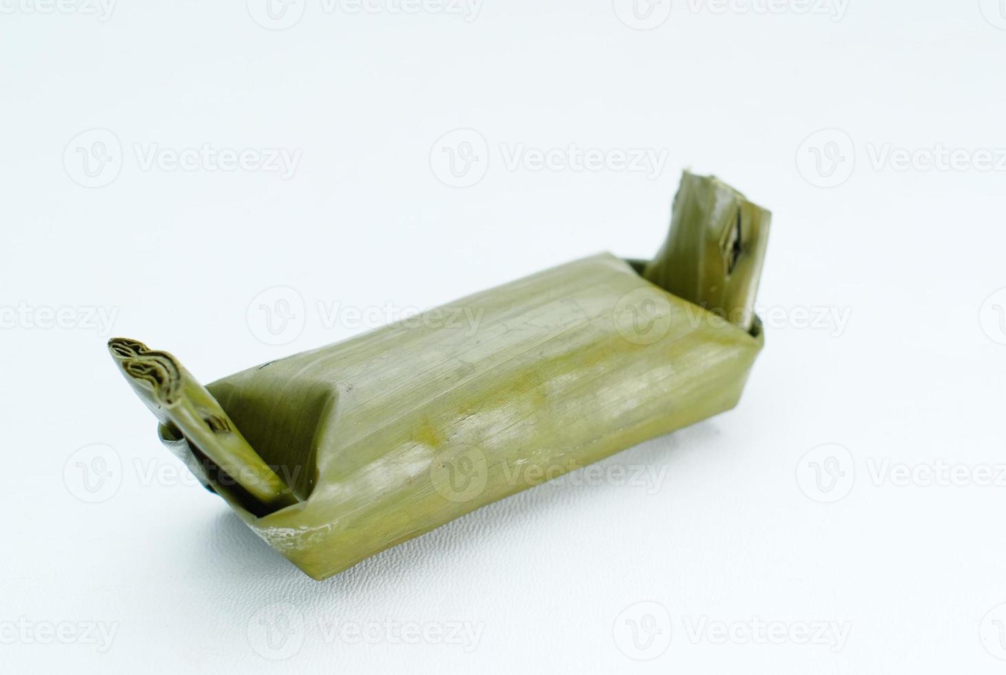 Arem-arem, Lemper, Lontong - traditional food wrapped in banana leaf on white background photo