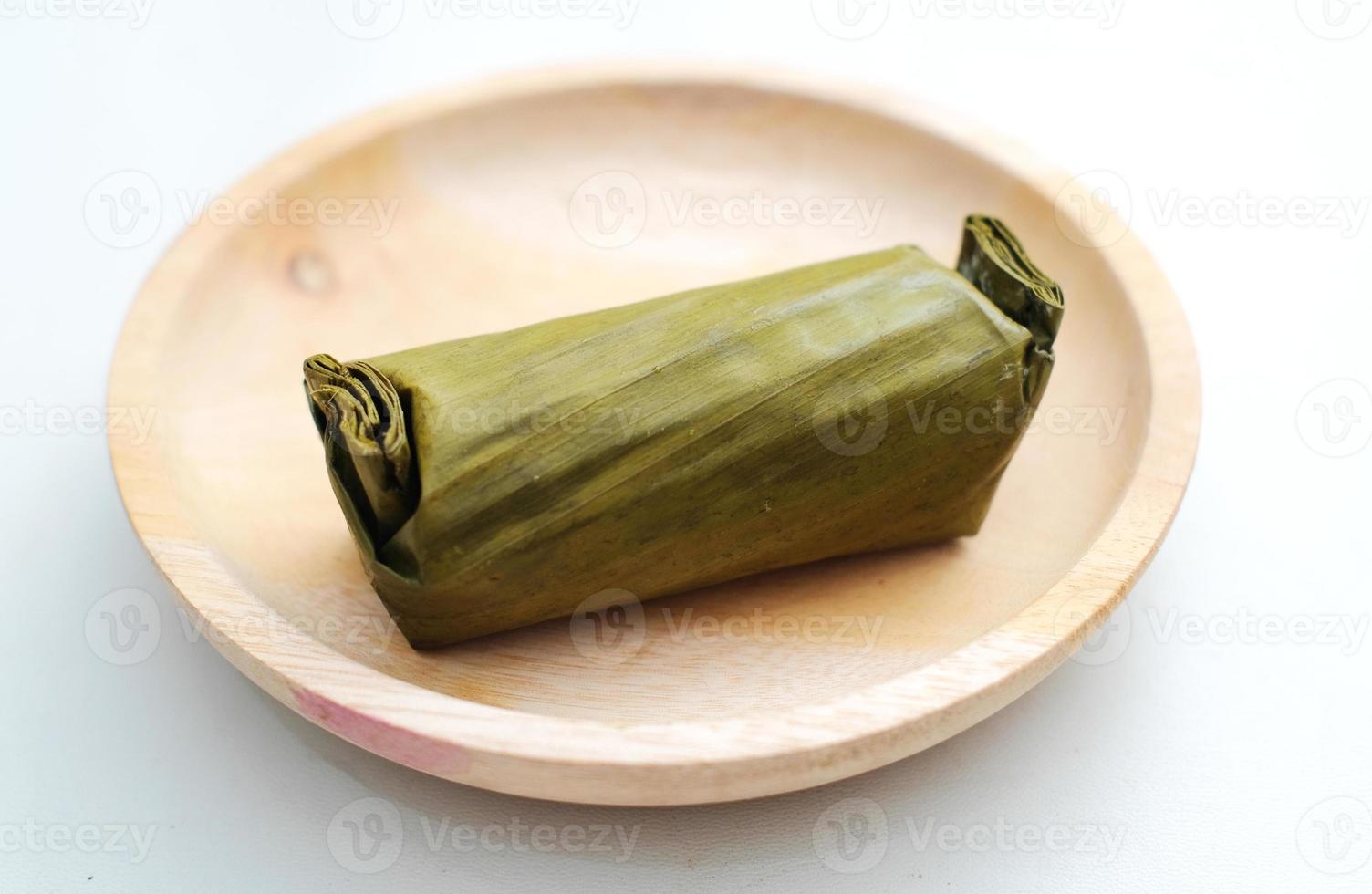 Arem-arem, Lemper, Lontong - traditional food wrapped in banana leaf on white background photo