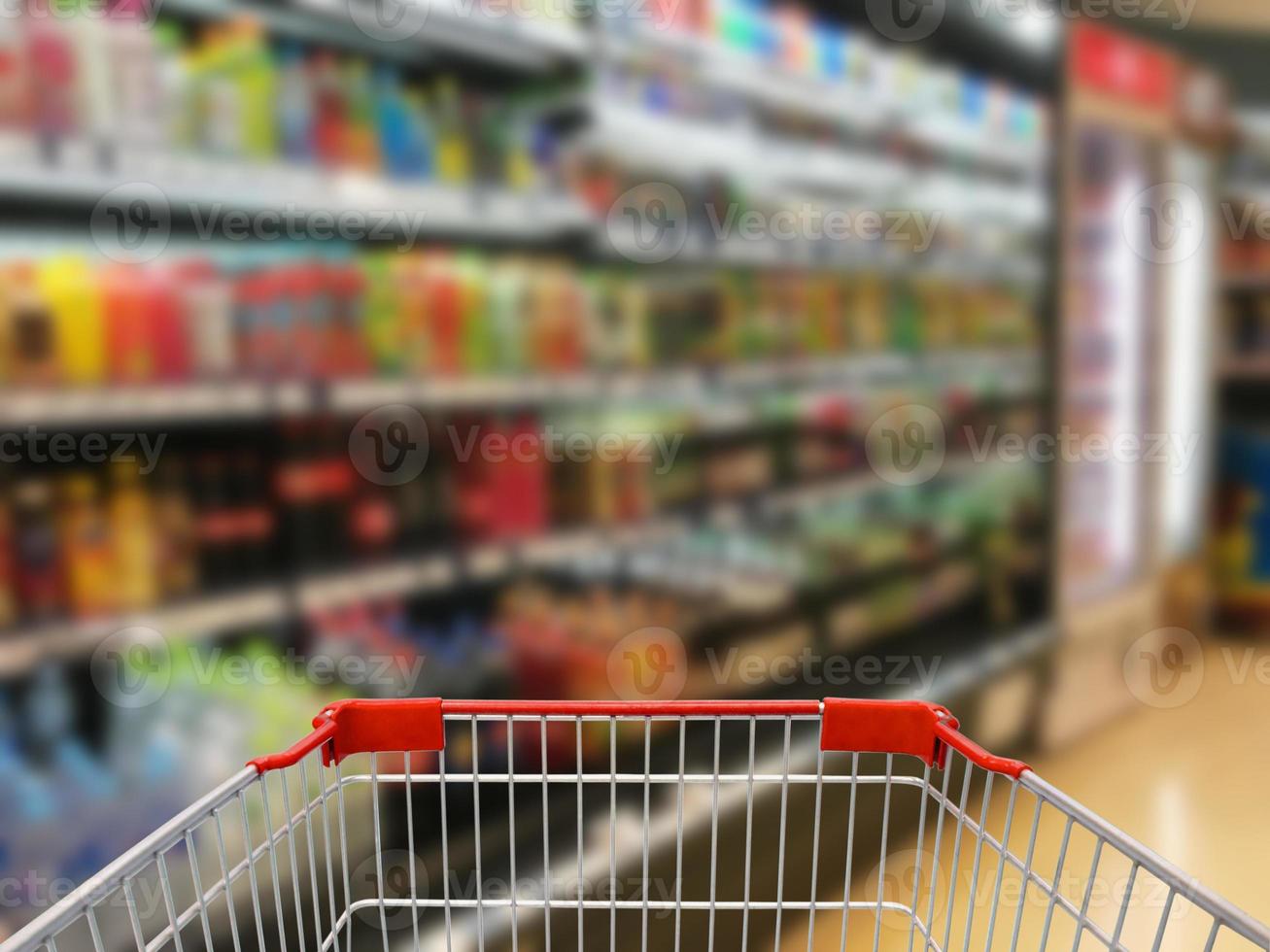 Supermarket interior, empty shopping cart photo