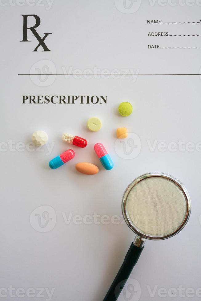 Pills and stethoscope on a prescription photo