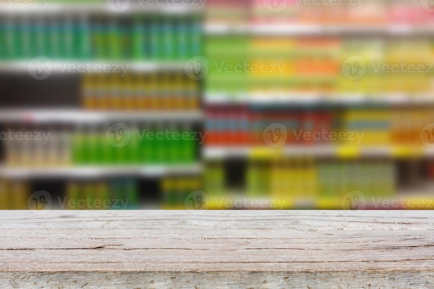 Empty table over blur view of beverage product on shelves in supermarket photo