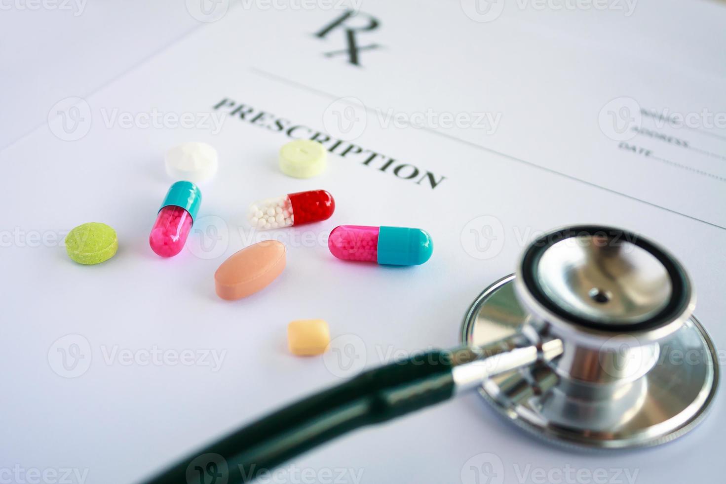 Pills and stethoscope on a prescription photo