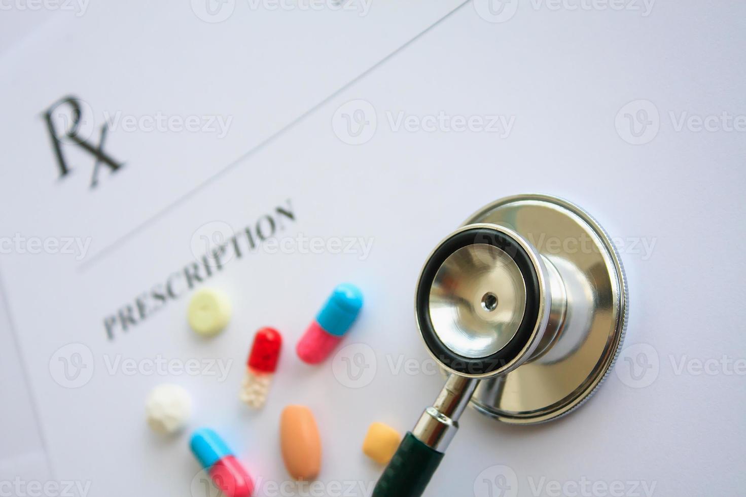 Pills and stethoscope on a prescription photo