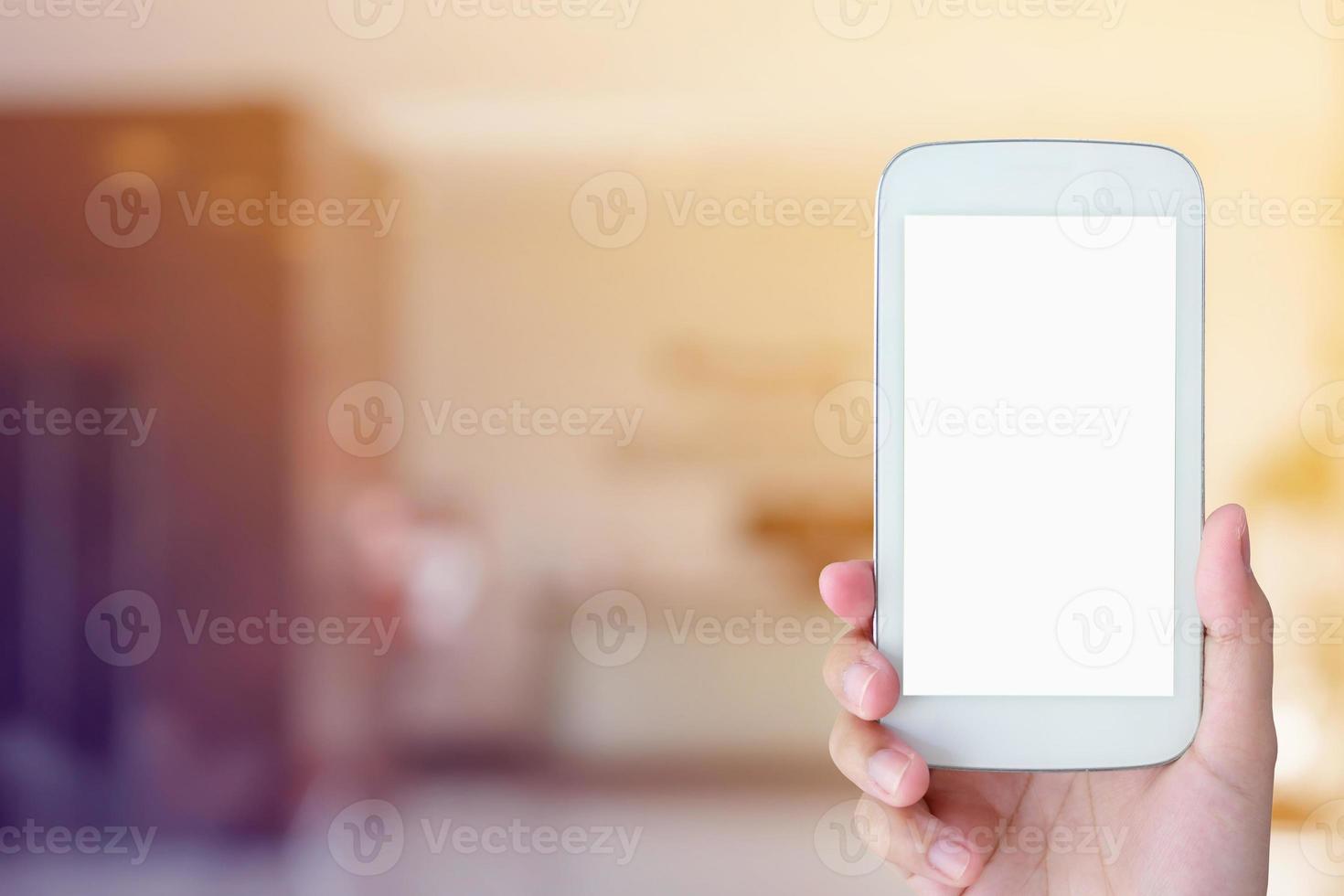 woman hand hold mobile smartphone with hotel lobby photo