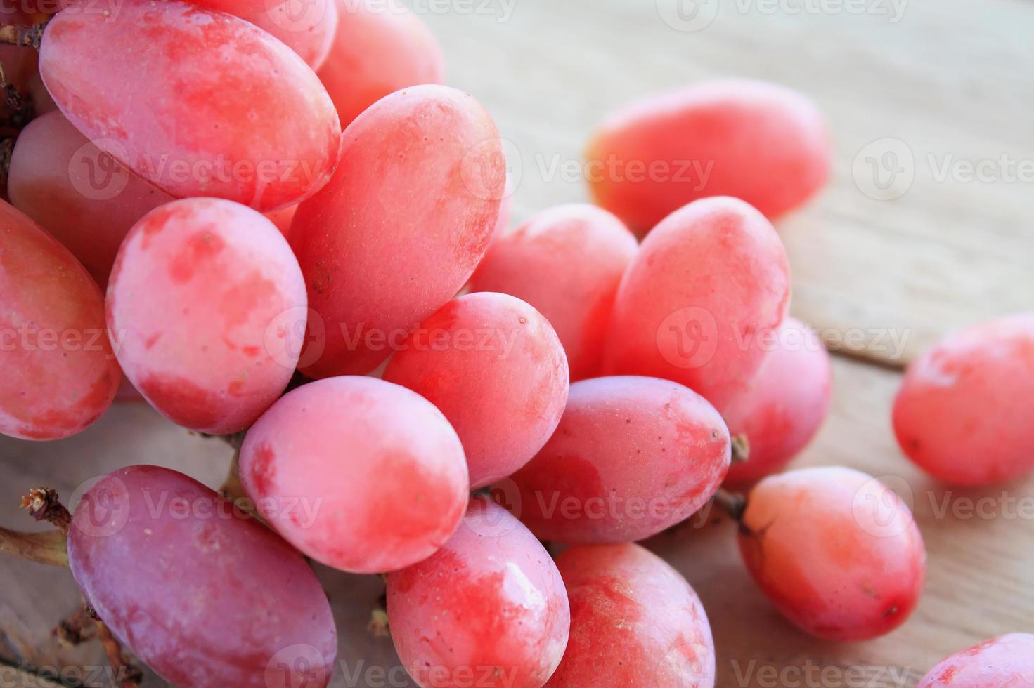 red grapes on wooden background photo