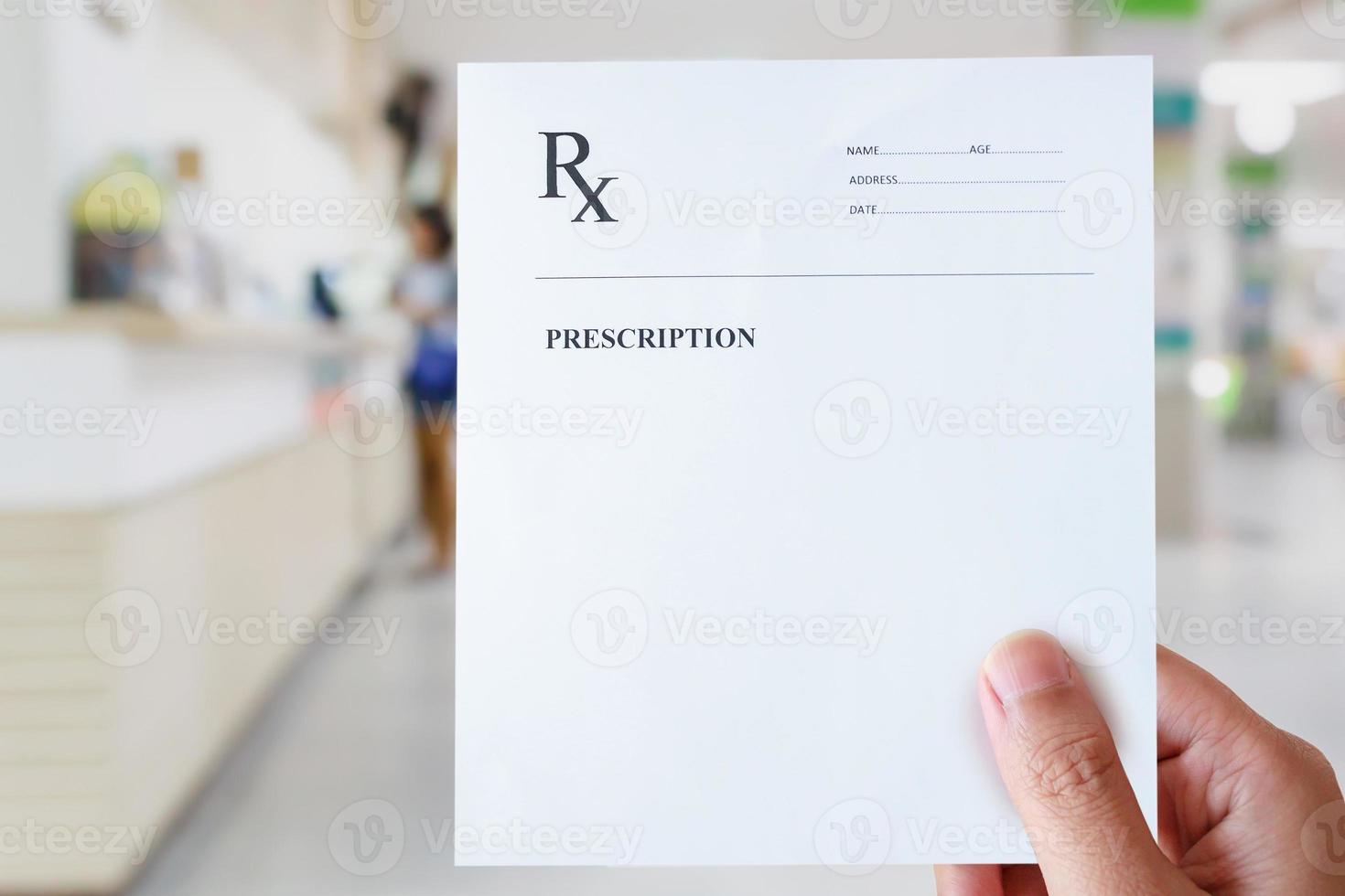 hand hold prescription paper with hospital background photo