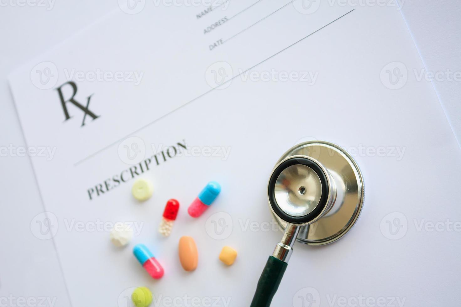 Pills and stethoscope on a prescription photo