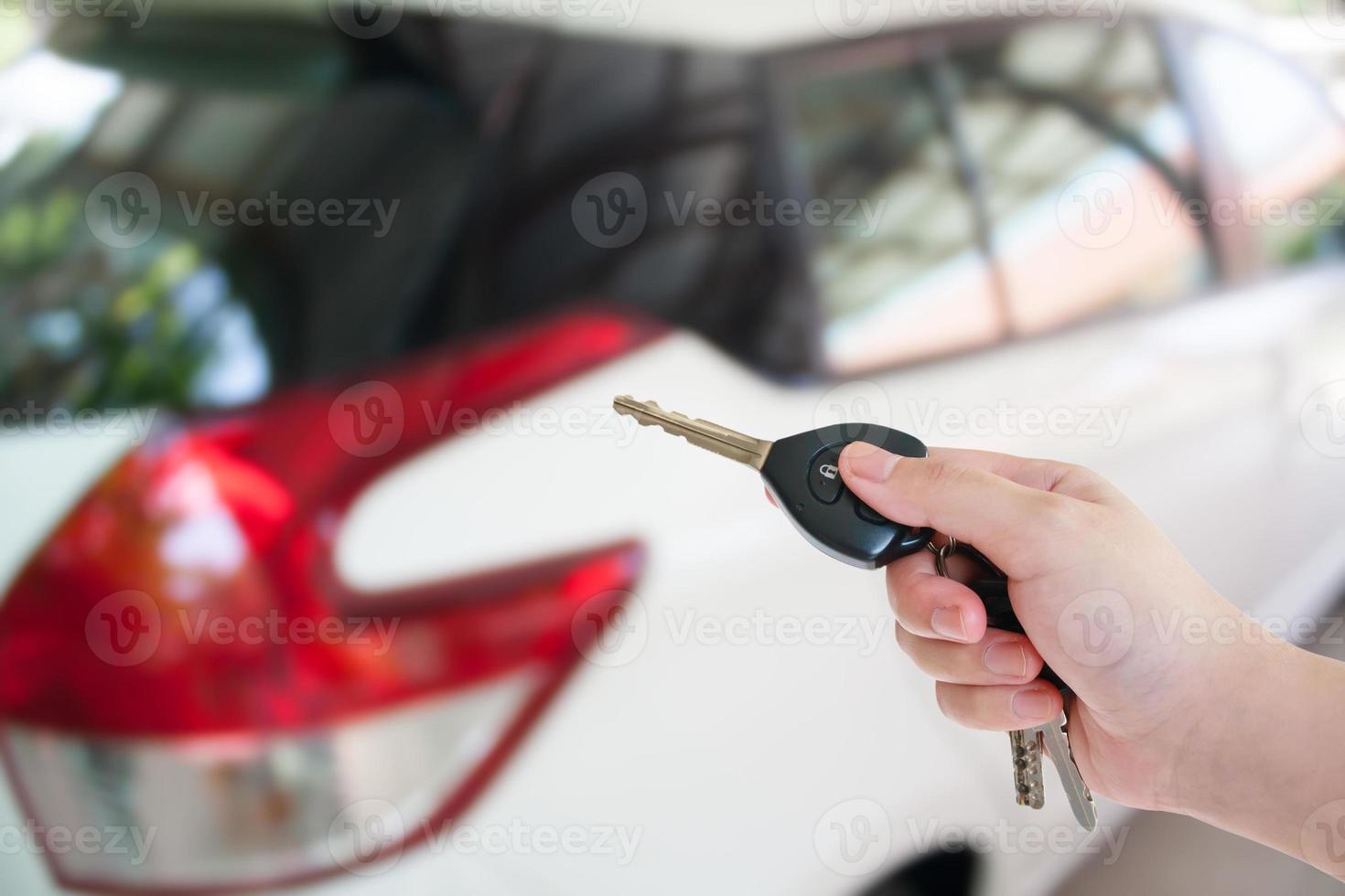 women hand presses on the remote control car alarm systems photo