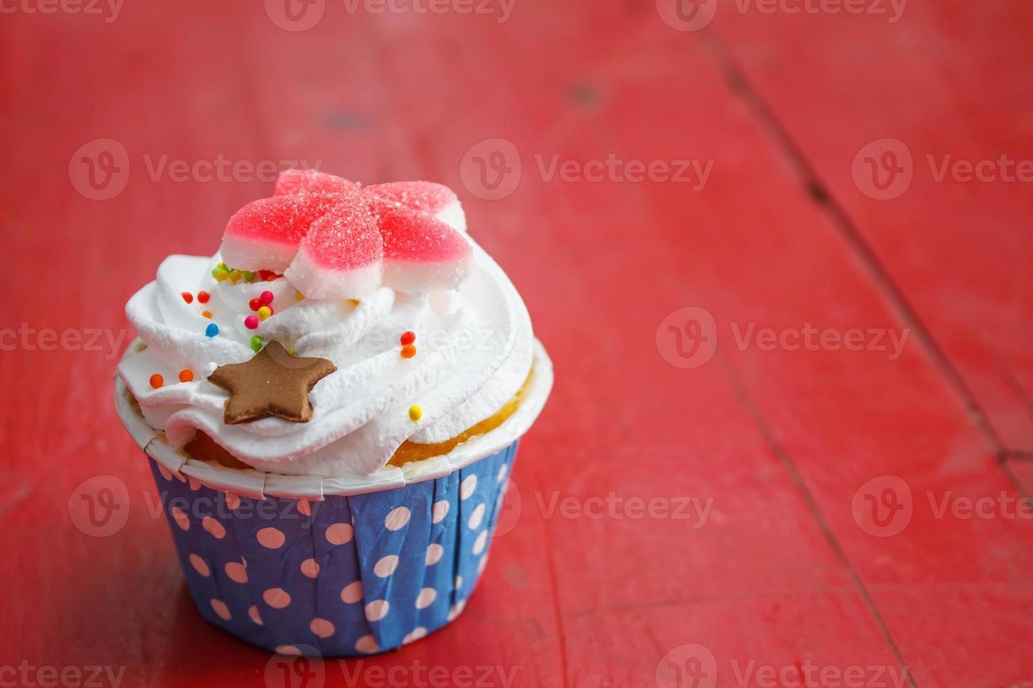 Tasty cupcakes with butter cream, on color wooden background photo