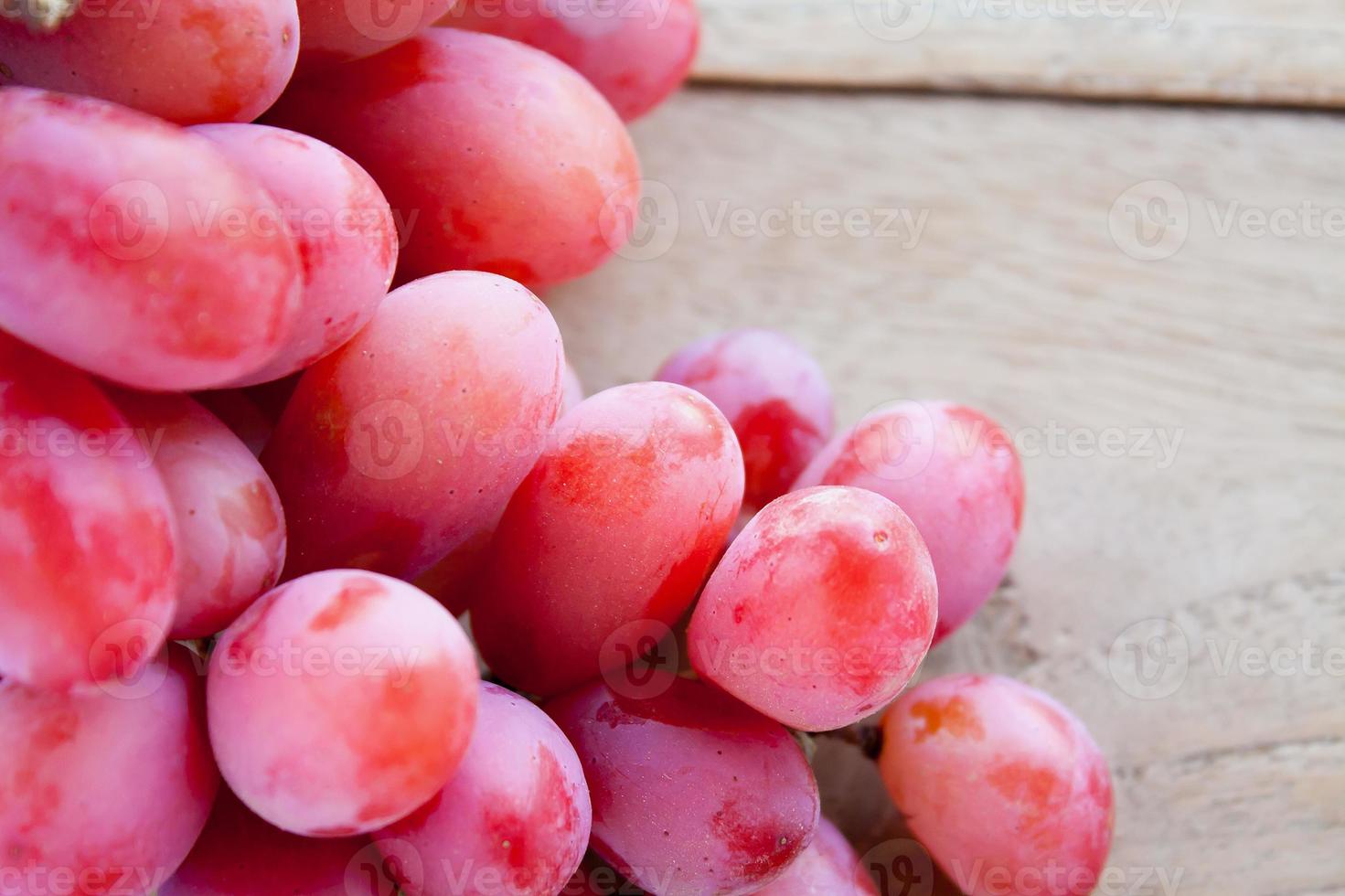 red grapes on wooden background photo