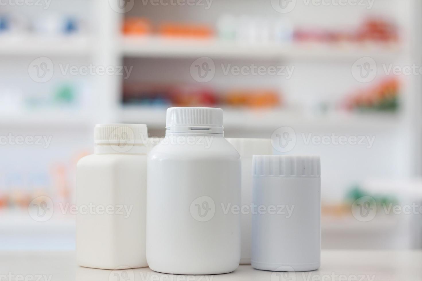 many medicine bottle with blur shelves of drug in the pharmacy drugstore background photo