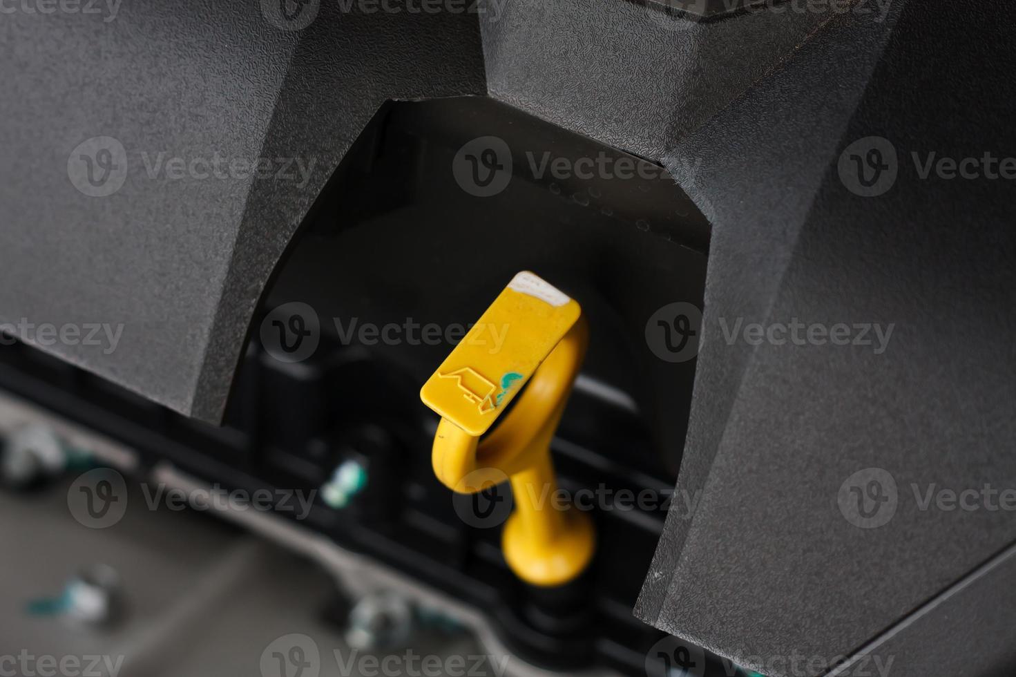 close up of car engine oil dip stick photo