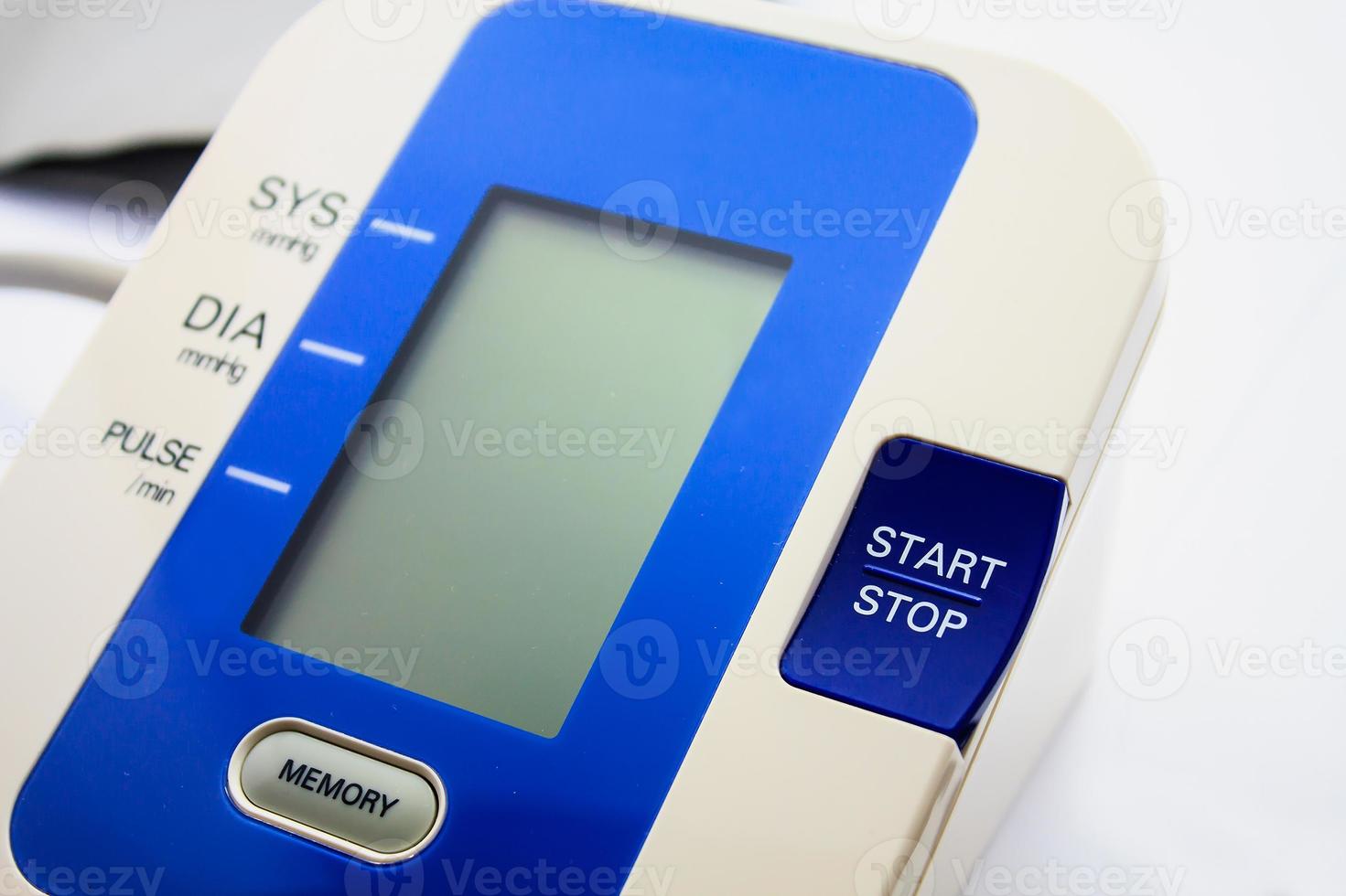Digital Blood Pressure Monitor on white background photo