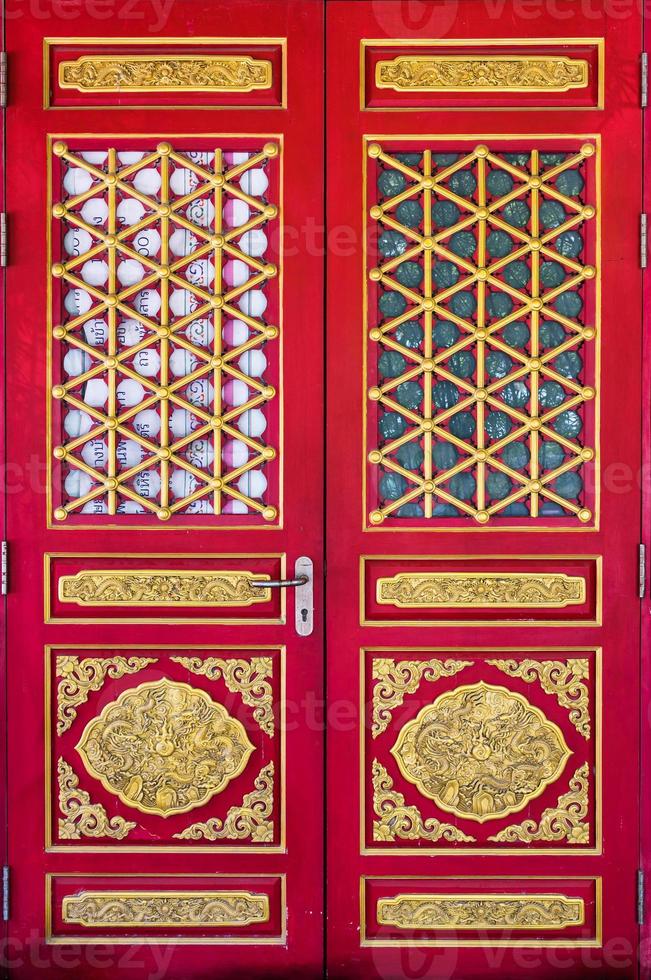 Ancient chinese red wooden door with dragon golden carve of chinese temple photo