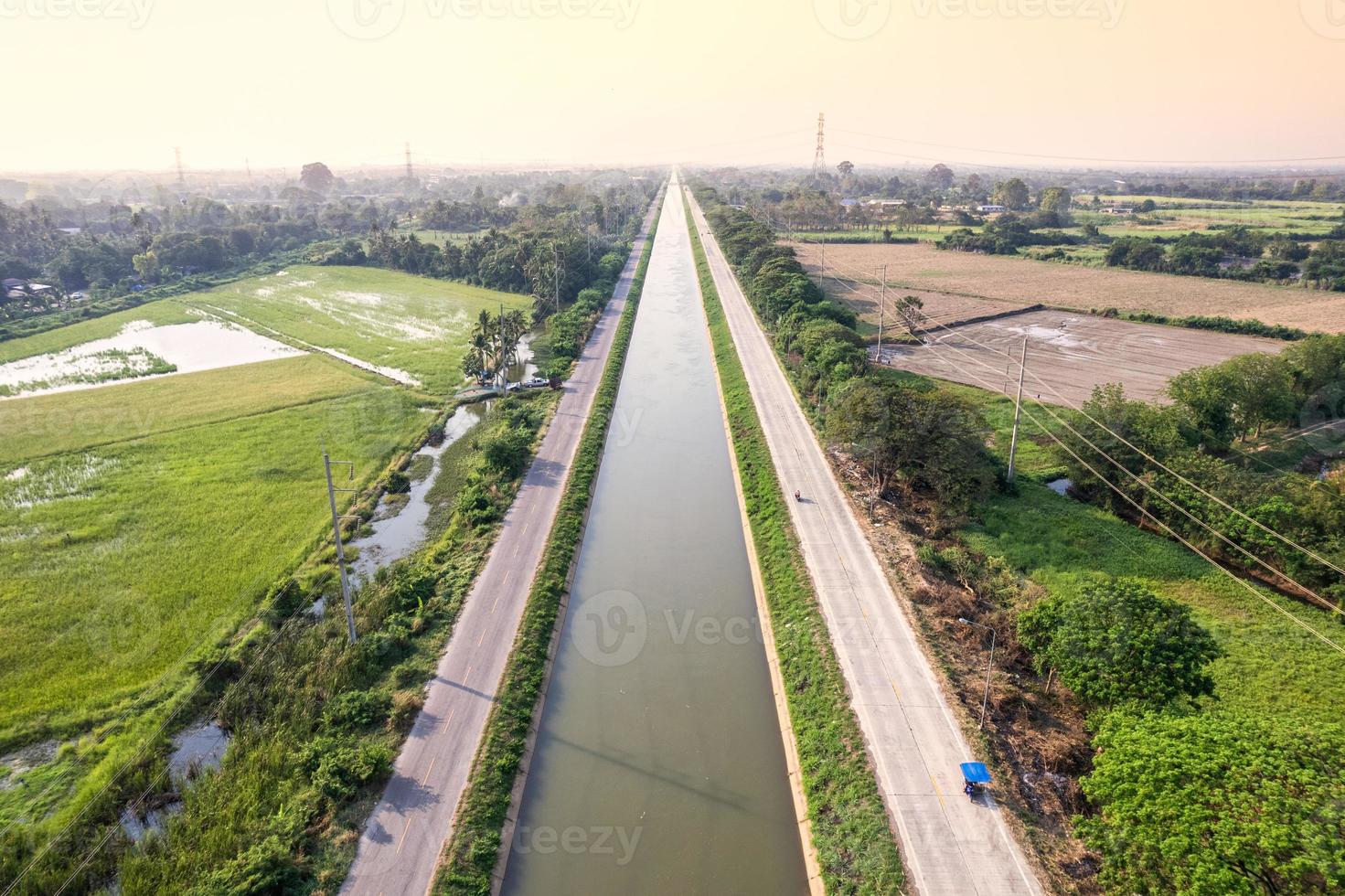 Aerial view of straight irrigation canal system management among the rice field and agronomic in countryside photo